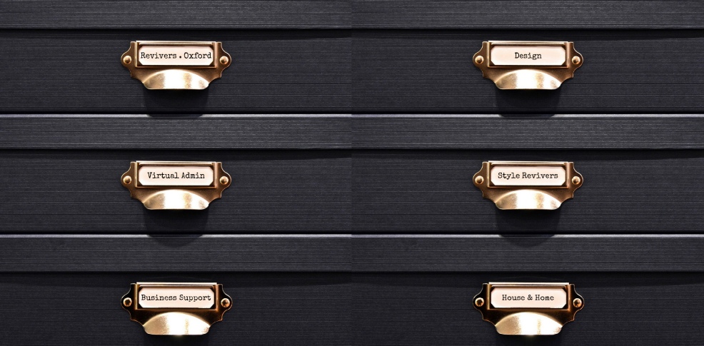 Vintage style black office filling cabinet with gold drawer labels and gold pull handles